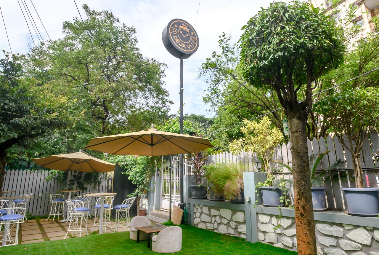 Cafe Dejavu outdoor signage and garden seating area